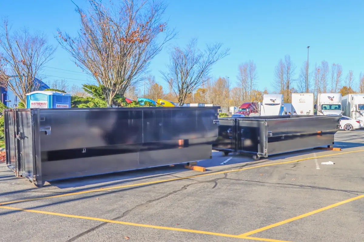 Professional dumpster rental service with roll-off container on residential driveway in East Lake-Orient Park